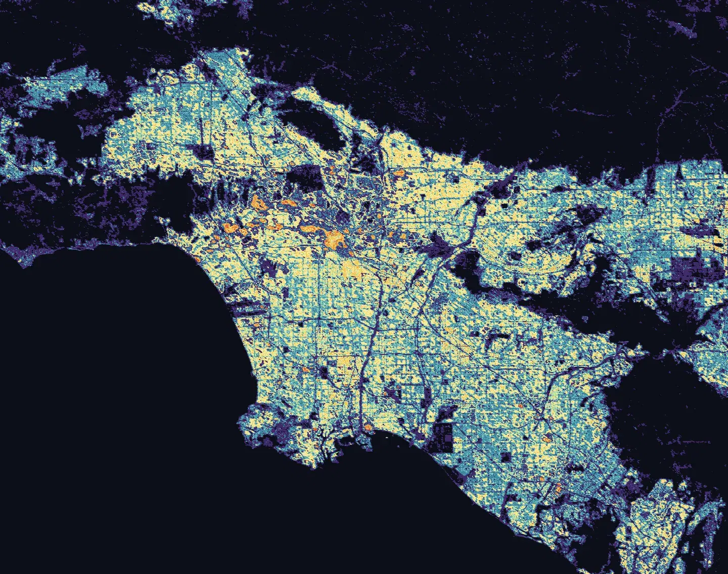 GAIA gridded building exposure across the Los Angeles basin, where color shows modeled built-up area per 100-meter grid cell, from dark blue in the lowest range to orange and red in the densest urban core