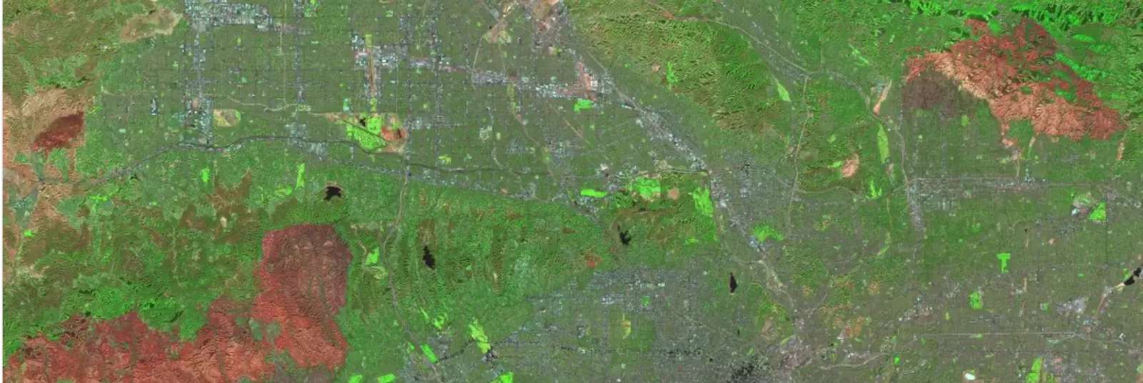 False-color satellite imagery of a city and surrounding terrain, as displayed in the Custom Visualization Tool