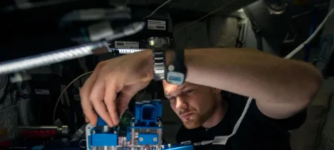 European Space Agency astronaut Alexander Gerst conducts a session with the Capillary Flow Experiment (CFE-2) in the Harmony node of the International Space Station.