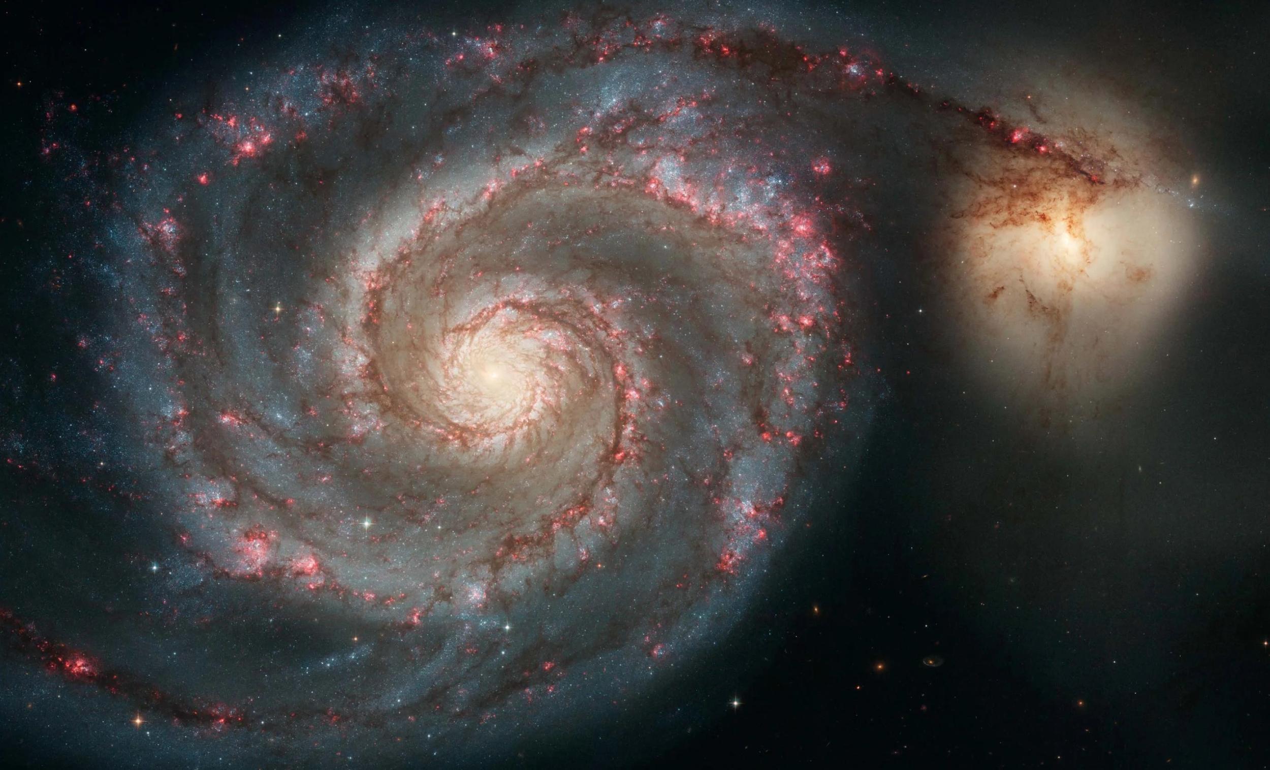 The Whirlpool Galaxy and smaller galaxy companion NGC 5195, as imaged by the Hubble Space Telescope.