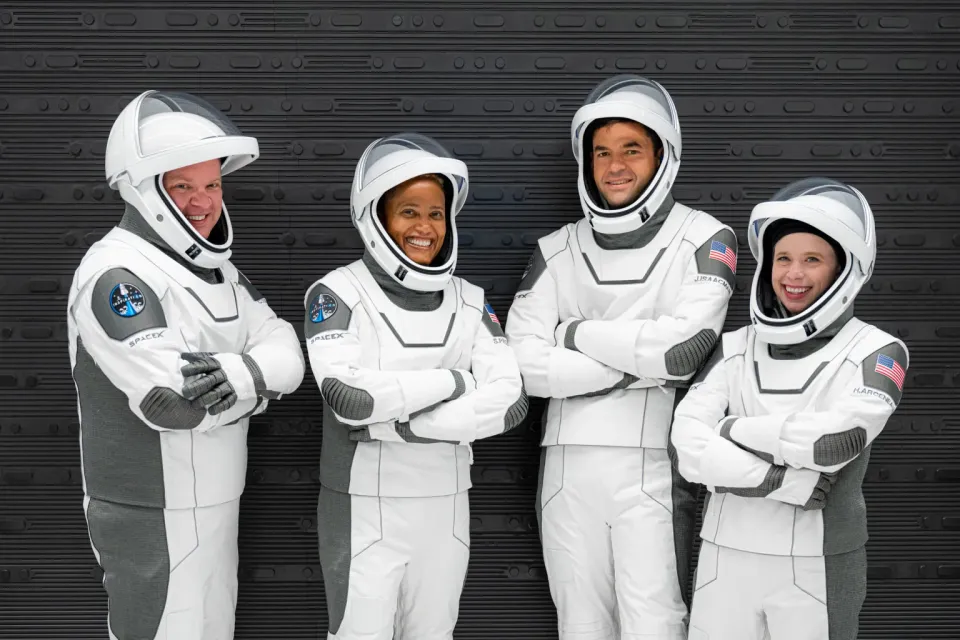 Astronauts from the Inspiration-4 commercial mission -- Christopher Sembroski, Sian Proctor, Jared Isaacman, and  Hayley Arceneaux -- pose in their spacesuits.